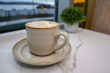 Cappuccino in front of window