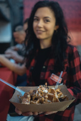 Young girl holding delicious dessert in hands on party