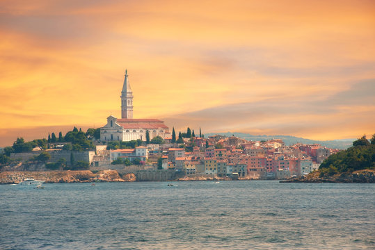 Rovinj, Croatia. Sunset over old town in Istria with Adriatic sea and orange blue sky