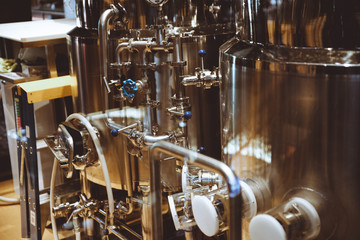 Fototapeta na wymiar Brewery for production of beer. Alcohol industry business background. Stainless steel equipment for producing beer alcohol drink. Beer production brewery tanks. Beer tanks.