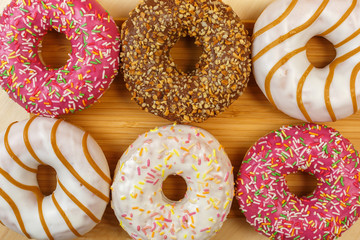 Glazed donuts on a wooden background