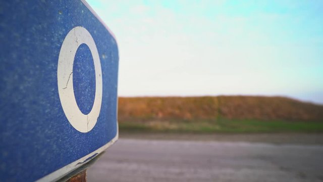 Zero road sign. Zero mile, kilometer. Check Point. Border of two countries. Equator. The beginning of the way. Fence on the cordon. Blue road sign. Traffic Laws. Travels. Tourism. Road for trucker.