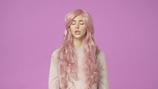 Slow-motion serious-looking displeased female in pink kawaii wig talking, having intense conversation, shake head in refusal, saying no, shaking hands, making stop gesture, rejecting, being reluctant
