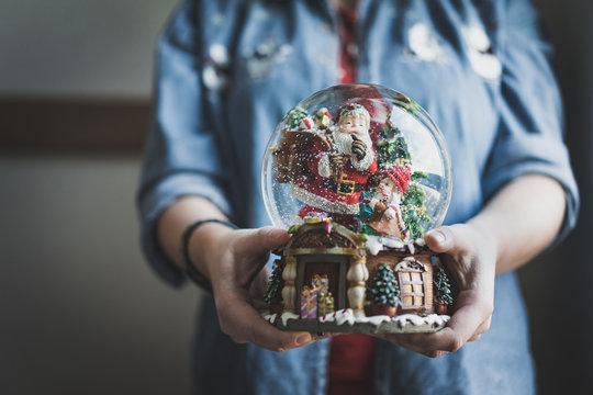 Woman Holding A Snowglobe