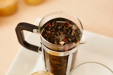 Tea with a teapot, cup and lemon jam. Natural fruit tea.