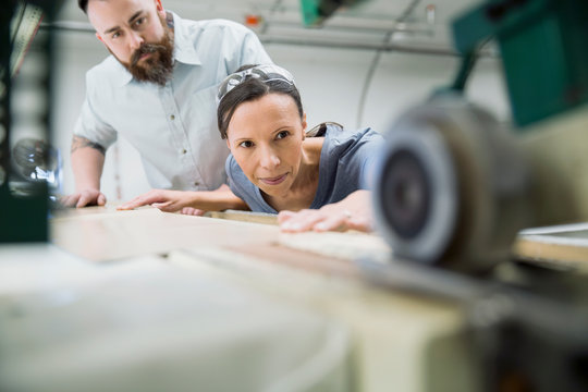 Workers Using Machinery In Textile Manufacturing Plant