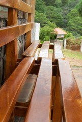 Detail of bench made of exposed wood with natural light outdoors in Guatemala, handmade crafts.