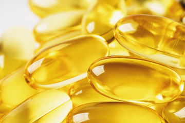 Omega 3 vitamin supplement gel capsules, medicine Fish Oil background, macro photo close-up.