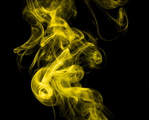 Obraz premium Yellow smoke on black background