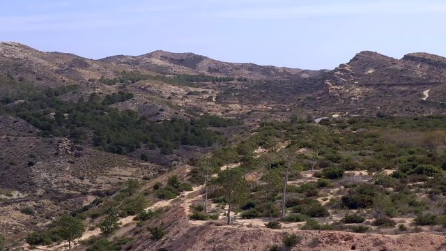 The aerial view of the rocky mountain in Cascada Pantano Elche in Spain