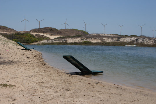 beautiful lake with windtower in background and chairs