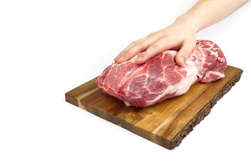 Fresh raw pork neck on wooden cutting board isolated on white. Male hand holding cutting board with pork meat.