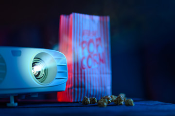 Concept of relaxing and watching movies. Projector and popcorn. Banner for design