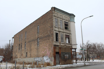 Abandoned Chicago graystone three-flat in Chicago's Englewood neighborhood in winter with graffiti