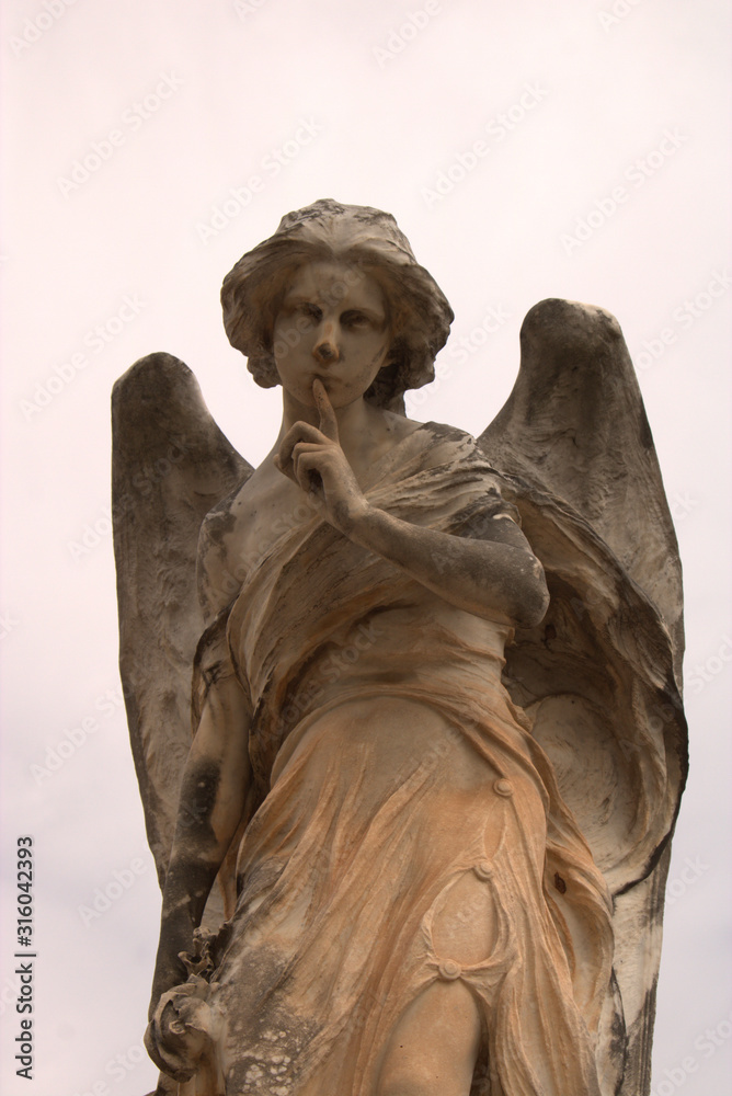 Wall mural cemetery angel making the silence sign