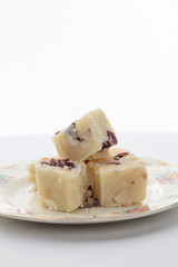 Delicious white fudge on a pretty plate with a white background
