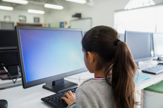 Elementary Student Using Computer In Classroom