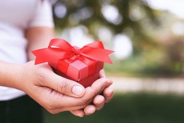 Gift box in hand for lovers on Valentine's Day, New Year, Christmas Day
