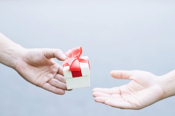 Gift box in hand for lovers on Valentine's Day, New Year, Christmas Day