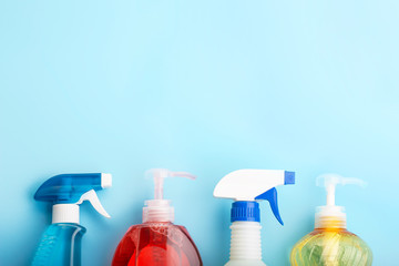Cleaning products on blue background with copy space, spring cleaning concert