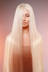 Model blonde with long healthy shiny hair. Woman wearing hair
