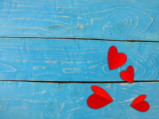 Valentine's Day .The heart shaped red paper on a blue wooden background