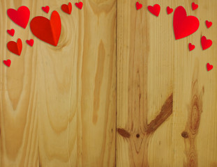 Valentine's Day .The heart shaped red paper on a wooden background