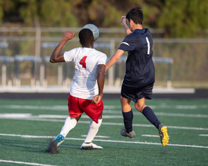 Obraz premium High School boy athletes making amazing plays during a soccer game