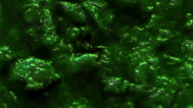 Ruined green pieces of seafood abstraction. Chemical radioactive mucus animation. Liquid with lumps. Colorful creative background.