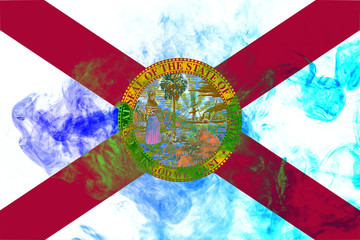 The national flag of the US state Florida in against a gray smoke on the day of independence in different colors of blue red and yellow. Political and religious disputes, customs and delivery.