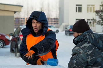 Two workers at the assembly site of the ice town