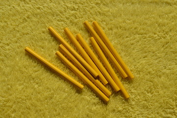 Sticks of wood color placed on a yellow background Use in learning.