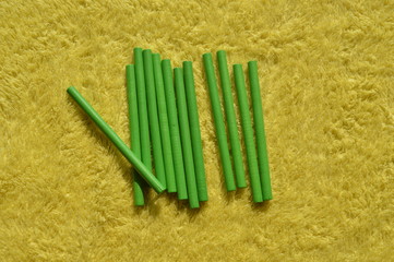 Sticks of wood color placed on a yellow background Use in learning.