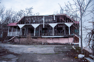 House tilted at an angle due to soil failure. Business failed. The resort complex. Gloomy abandoned buildings.