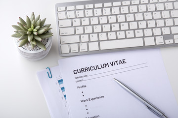 Curriculum vitae with pen and keyboard