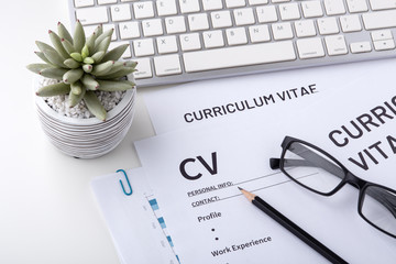 CV, curriculum vitae with keyboard on whtie desk