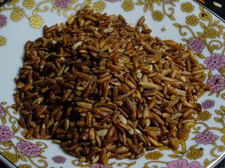 Red/brown rice isolated on black background