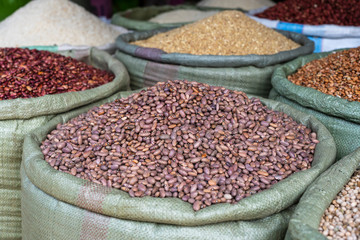 Assortment of dry beans in for sale at a local street food market on the island of Zanzibar, Tanzania, Africa - obrazy, fototapety, plakaty