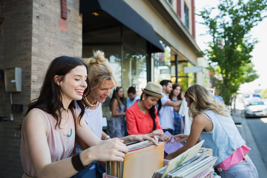 Women browsing records at sidewalk sale