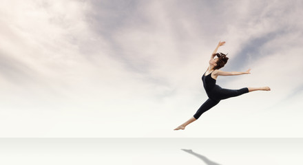 Fototapeta premium Gymnast girl in jump Mixed media