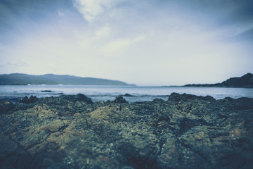 beach rock and stone to show with beach in background