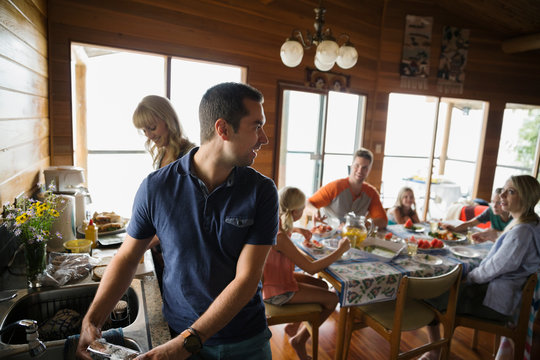 Family preparing lunch in cabin