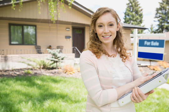 Portrait Of Confident Realtor Outside House