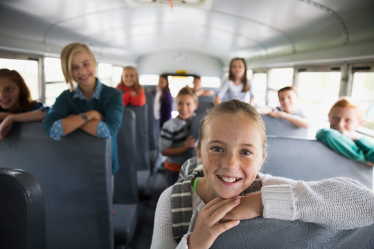 Portrait confident school kids on school bus