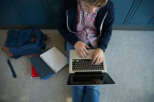 Overhead view high school student using laptop