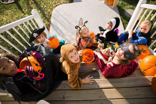 Overhead Portrait Kids Halloween Costumes Sitting Front Stoop