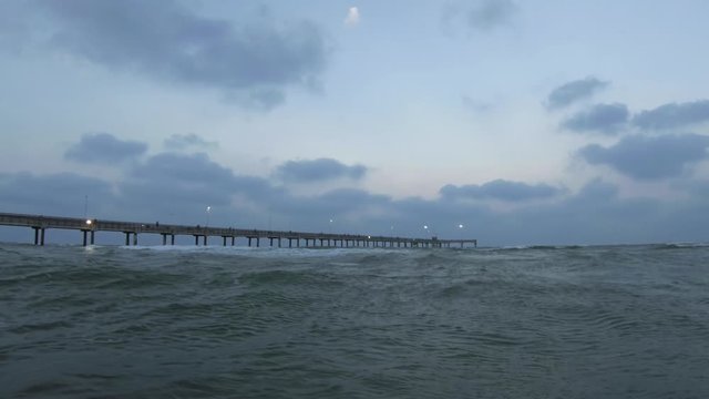 View of sea and pier on a cludy day