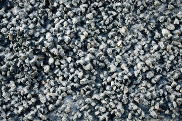 gray small stones in frost, gravel background