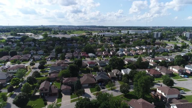 Areial Over Suburban Middle Class Homes In Summer With White Clouds Blue Ksy Drone 002