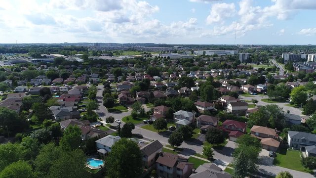 Areial Over Suburban Middle Class Homes In Summer With White Clouds Blue Ksy Drone